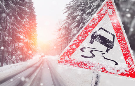 Schneebedeckte Straße mit Verkehrszeichen 